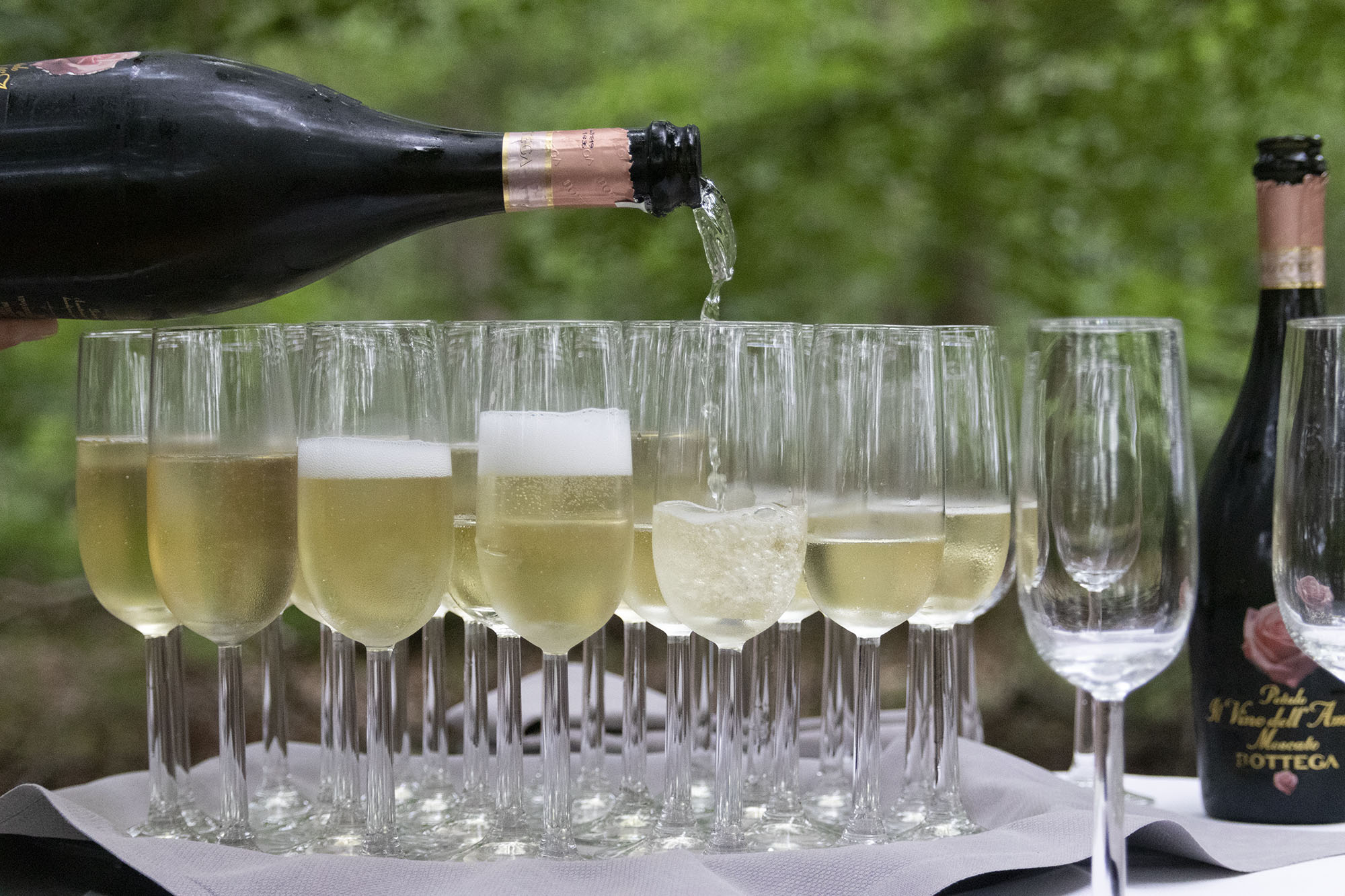 Glasses of champagne being filled wedding photographer wedding photography
